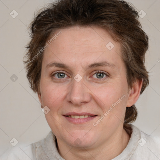 Joyful white adult female with medium  brown hair and blue eyes