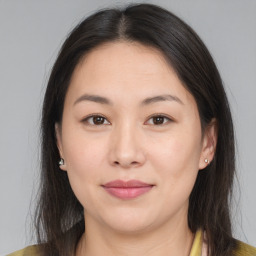 Joyful asian young-adult female with medium  brown hair and brown eyes