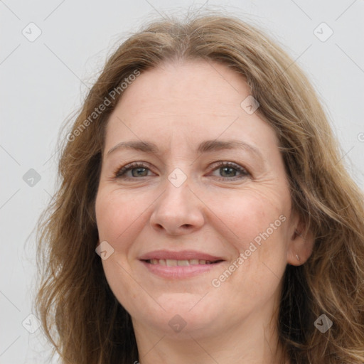 Joyful white adult female with long  brown hair and brown eyes