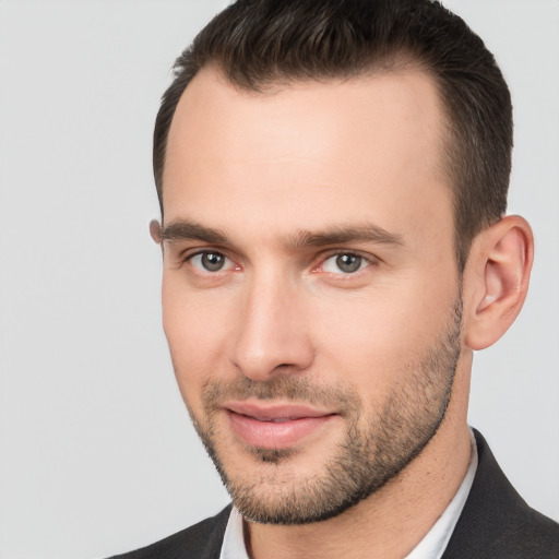 Joyful white young-adult male with short  brown hair and brown eyes