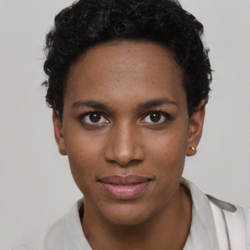 Joyful black young-adult female with short  brown hair and brown eyes