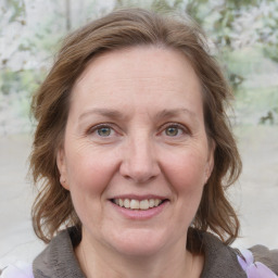 Joyful white adult female with medium  brown hair and grey eyes