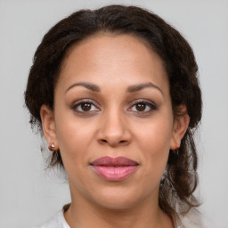 Joyful latino young-adult female with medium  brown hair and brown eyes