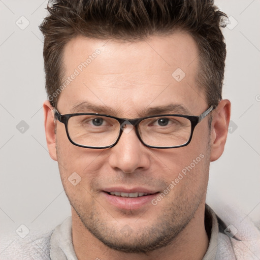 Joyful white adult male with short  brown hair and grey eyes