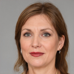 Joyful white adult female with medium  brown hair and grey eyes