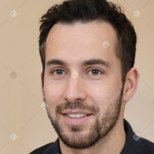 Joyful white young-adult male with short  black hair and brown eyes