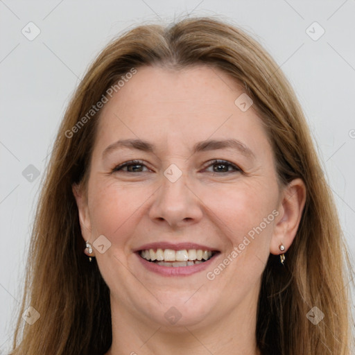 Joyful white adult female with long  brown hair and grey eyes