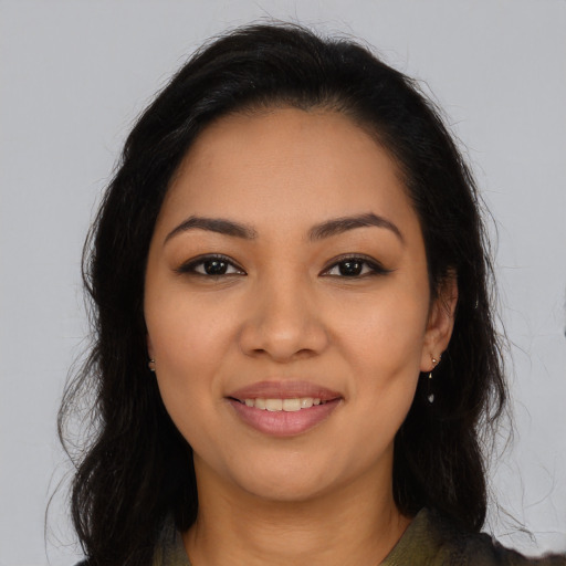 Joyful latino young-adult female with long  brown hair and brown eyes