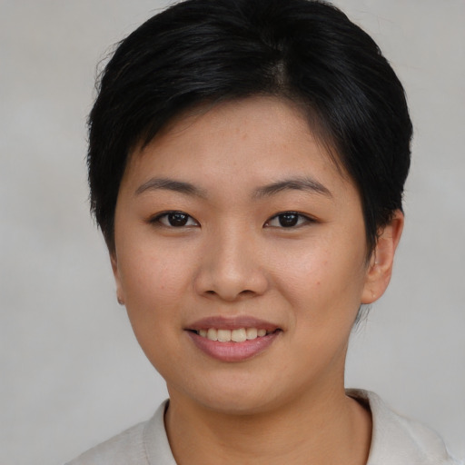 Joyful asian young-adult female with short  brown hair and brown eyes