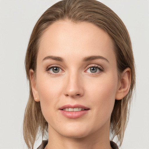 Joyful white young-adult female with medium  brown hair and grey eyes