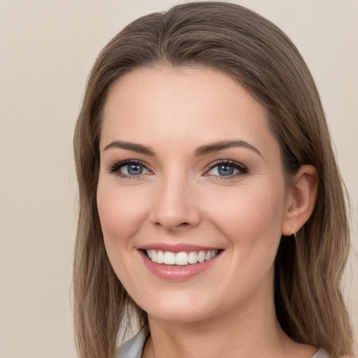 Joyful white young-adult female with long  brown hair and grey eyes