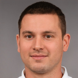 Joyful white young-adult male with short  brown hair and brown eyes