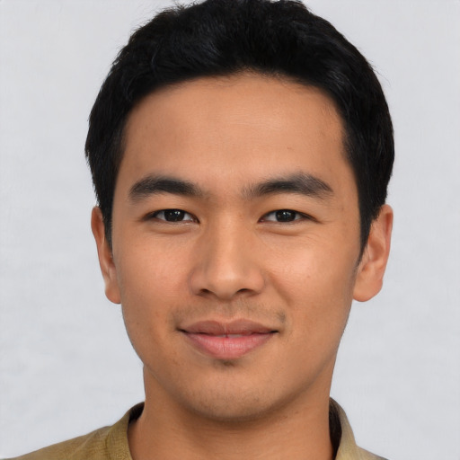 Joyful asian young-adult male with short  black hair and brown eyes