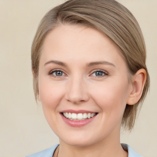 Joyful white young-adult female with medium  brown hair and grey eyes