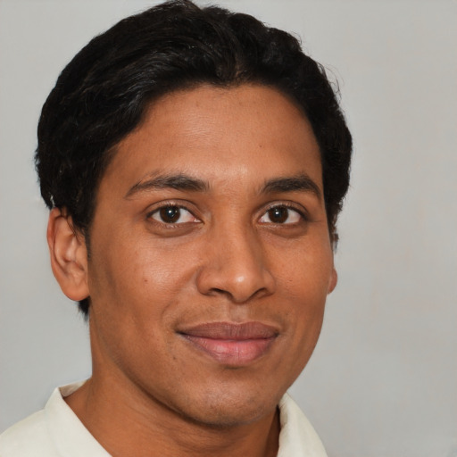 Joyful latino adult male with short  brown hair and brown eyes