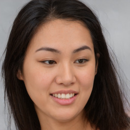 Joyful asian young-adult female with long  brown hair and brown eyes