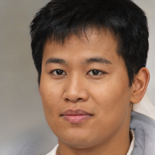 Joyful asian young-adult male with short  brown hair and brown eyes