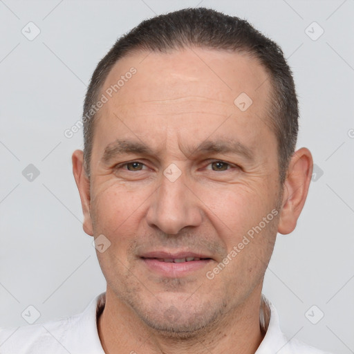 Joyful white adult male with short  brown hair and brown eyes