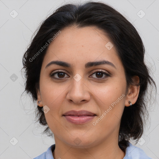 Joyful latino young-adult female with medium  brown hair and brown eyes