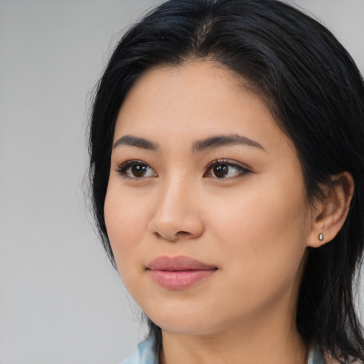Joyful latino young-adult female with medium  black hair and brown eyes