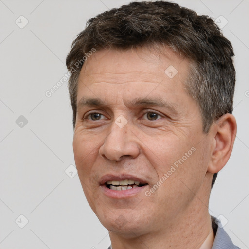 Joyful white adult male with short  brown hair and brown eyes