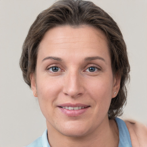 Joyful white adult female with short  brown hair and grey eyes