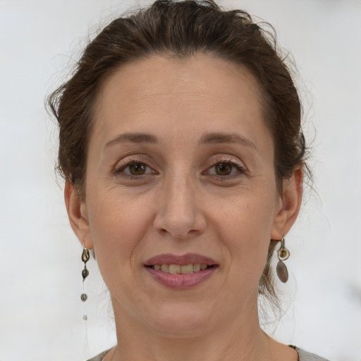 Joyful white adult female with short  brown hair and grey eyes