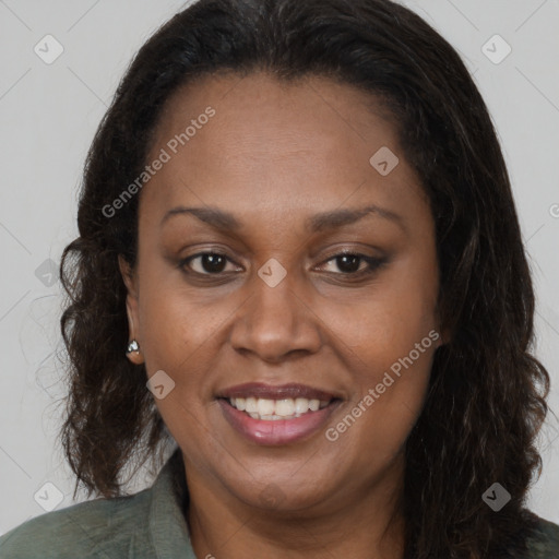 Joyful black adult female with long  brown hair and brown eyes