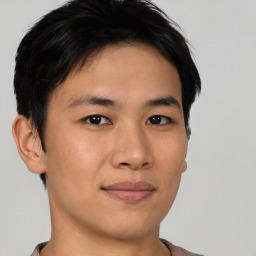 Joyful asian young-adult male with short  brown hair and brown eyes