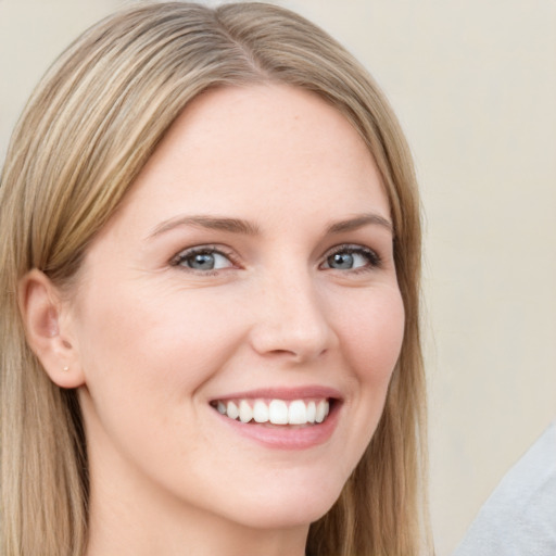 Joyful white young-adult female with long  brown hair and green eyes