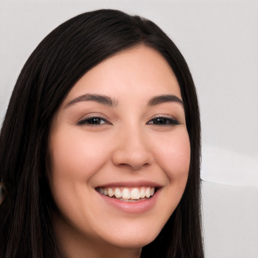 Joyful white young-adult female with long  black hair and brown eyes