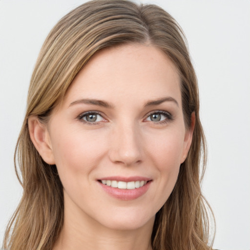 Joyful white young-adult female with long  brown hair and grey eyes