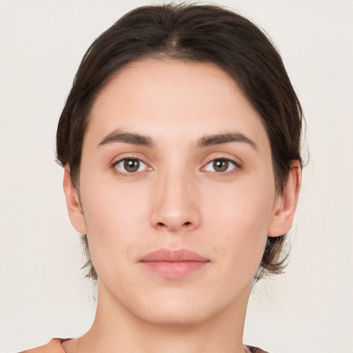 Neutral white young-adult female with short  brown hair and brown eyes