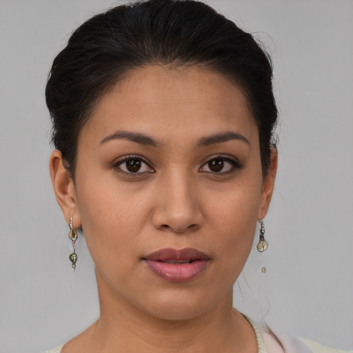 Joyful latino young-adult female with short  brown hair and brown eyes