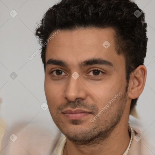 Joyful latino young-adult male with short  black hair and brown eyes