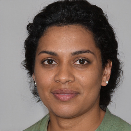Joyful black young-adult female with medium  black hair and brown eyes
