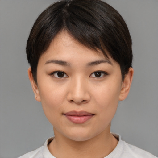Joyful asian young-adult female with short  brown hair and brown eyes