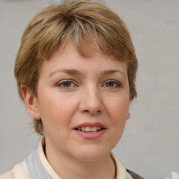 Joyful white young-adult female with medium  brown hair and blue eyes