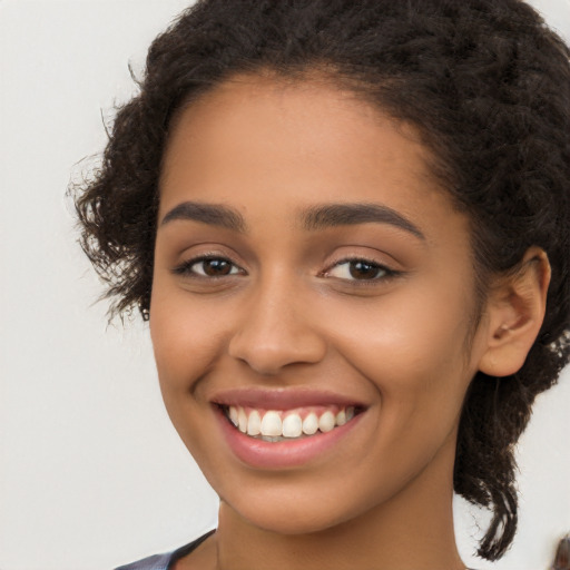 Joyful latino young-adult female with long  brown hair and brown eyes