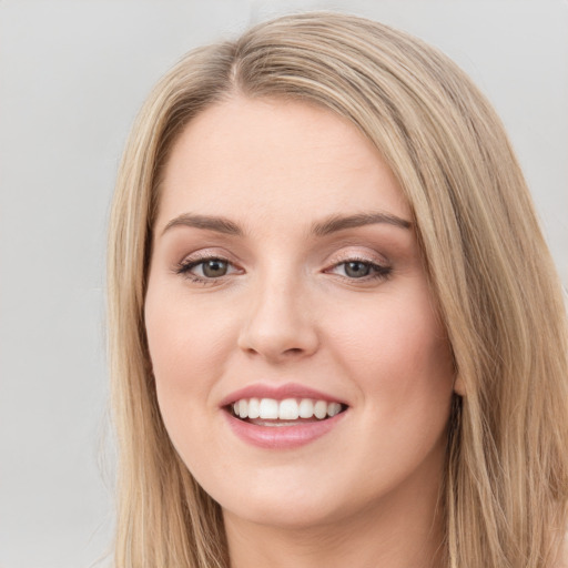 Joyful white young-adult female with long  brown hair and green eyes