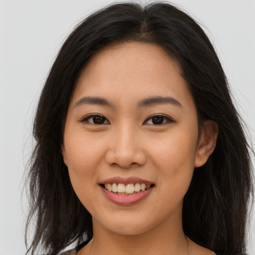 Joyful asian young-adult female with long  brown hair and brown eyes