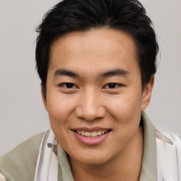 Joyful asian young-adult male with short  brown hair and brown eyes