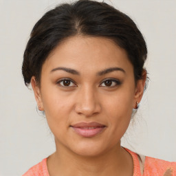 Joyful latino young-adult female with medium  brown hair and brown eyes