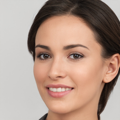 Joyful white young-adult female with long  brown hair and brown eyes