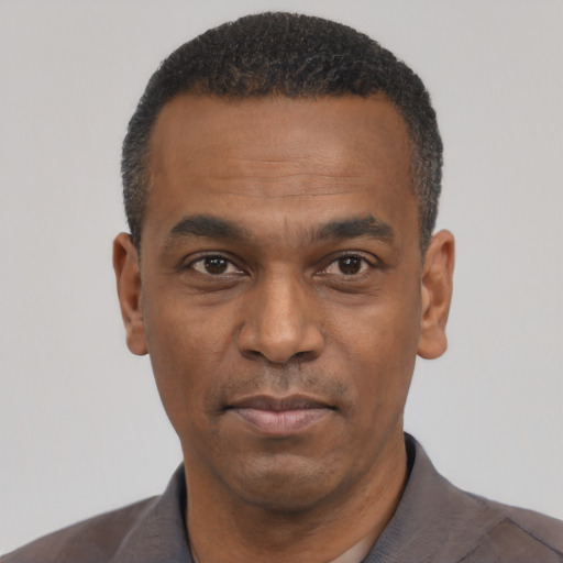 Neutral black adult male with short  black hair and brown eyes