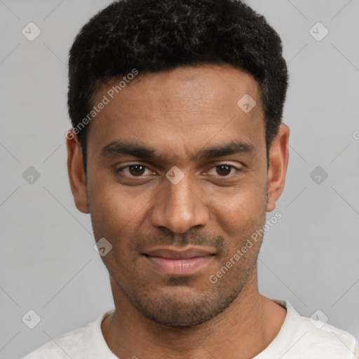 Joyful black young-adult male with short  black hair and brown eyes