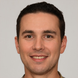 Joyful white young-adult male with short  brown hair and brown eyes