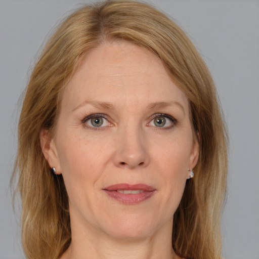 Joyful white adult female with medium  brown hair and grey eyes