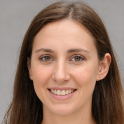 Joyful white young-adult female with long  brown hair and grey eyes