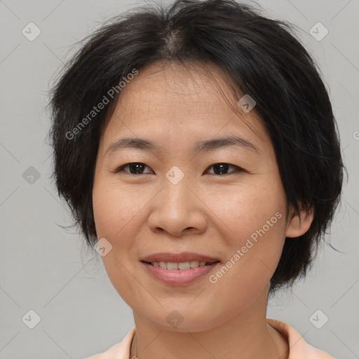 Joyful asian adult female with medium  brown hair and brown eyes